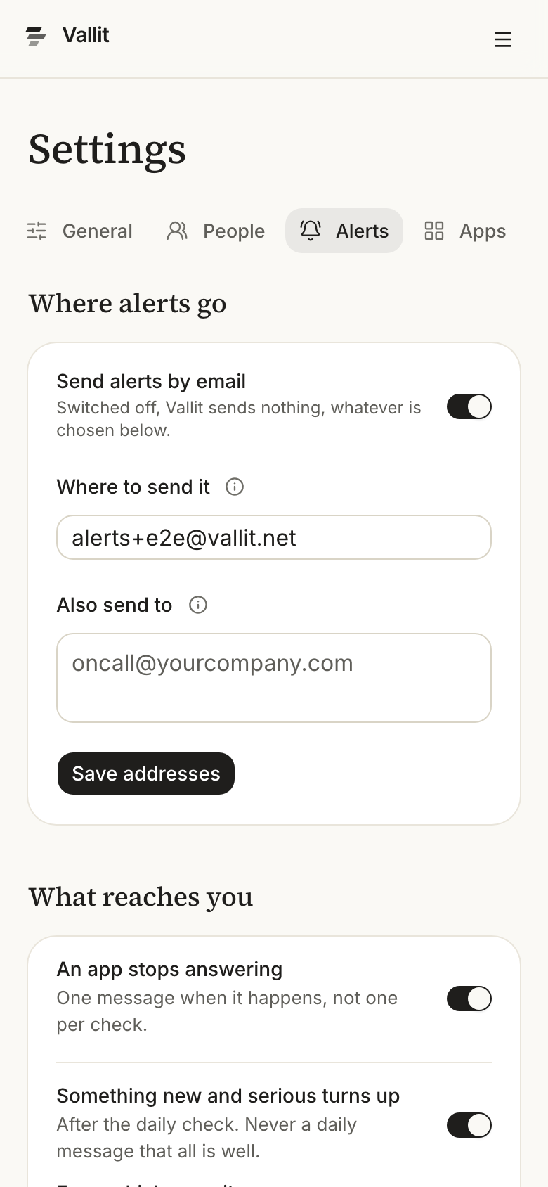 The Alerts section of the company settings with the Where alerts go card ringed: the Send alerts by email switch, the address fields and Save addresses. The What reaches you card with its three switches follows it. On a phone.